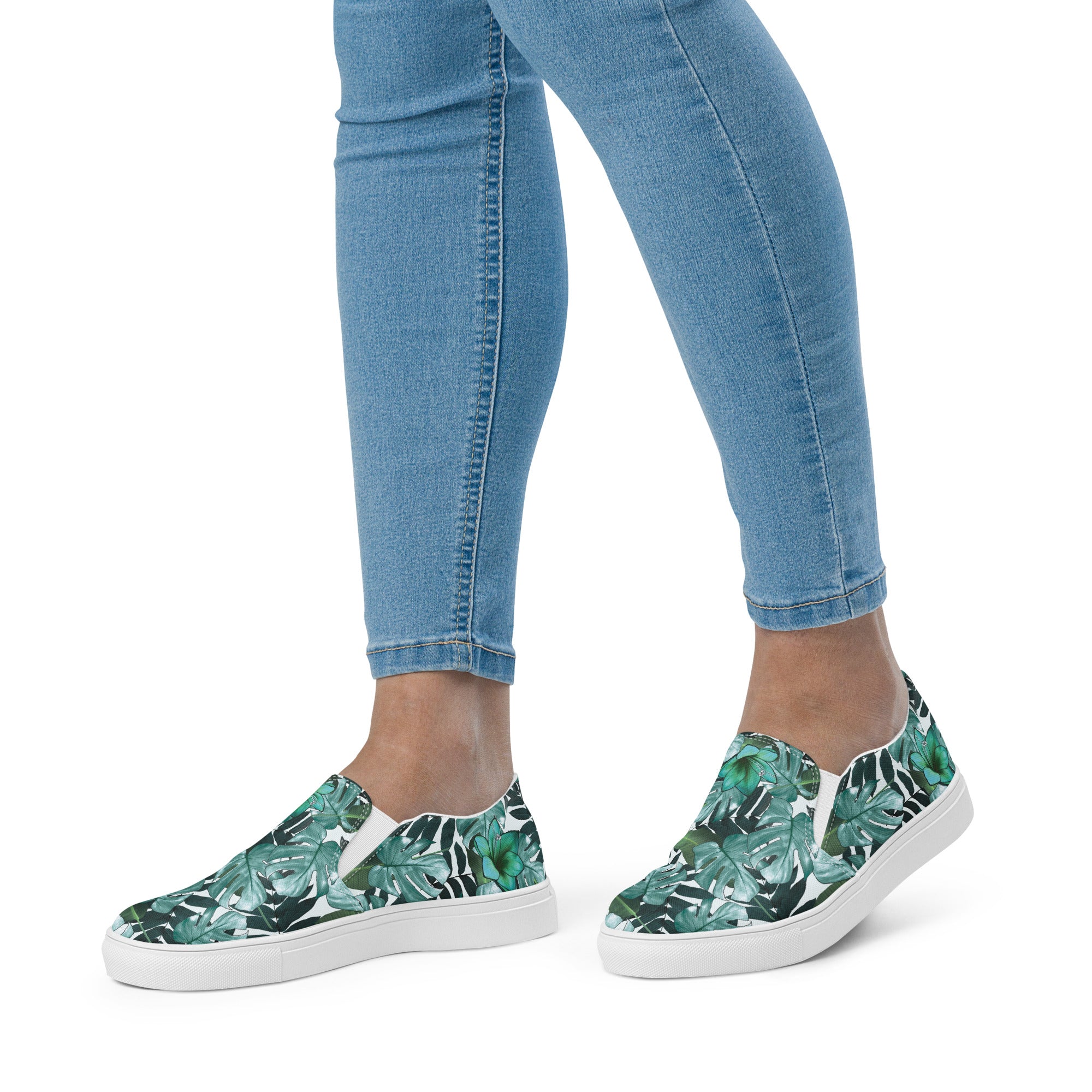 multicolor green tropical print canvas slip on shoes on a womans foot side view of her in jeans