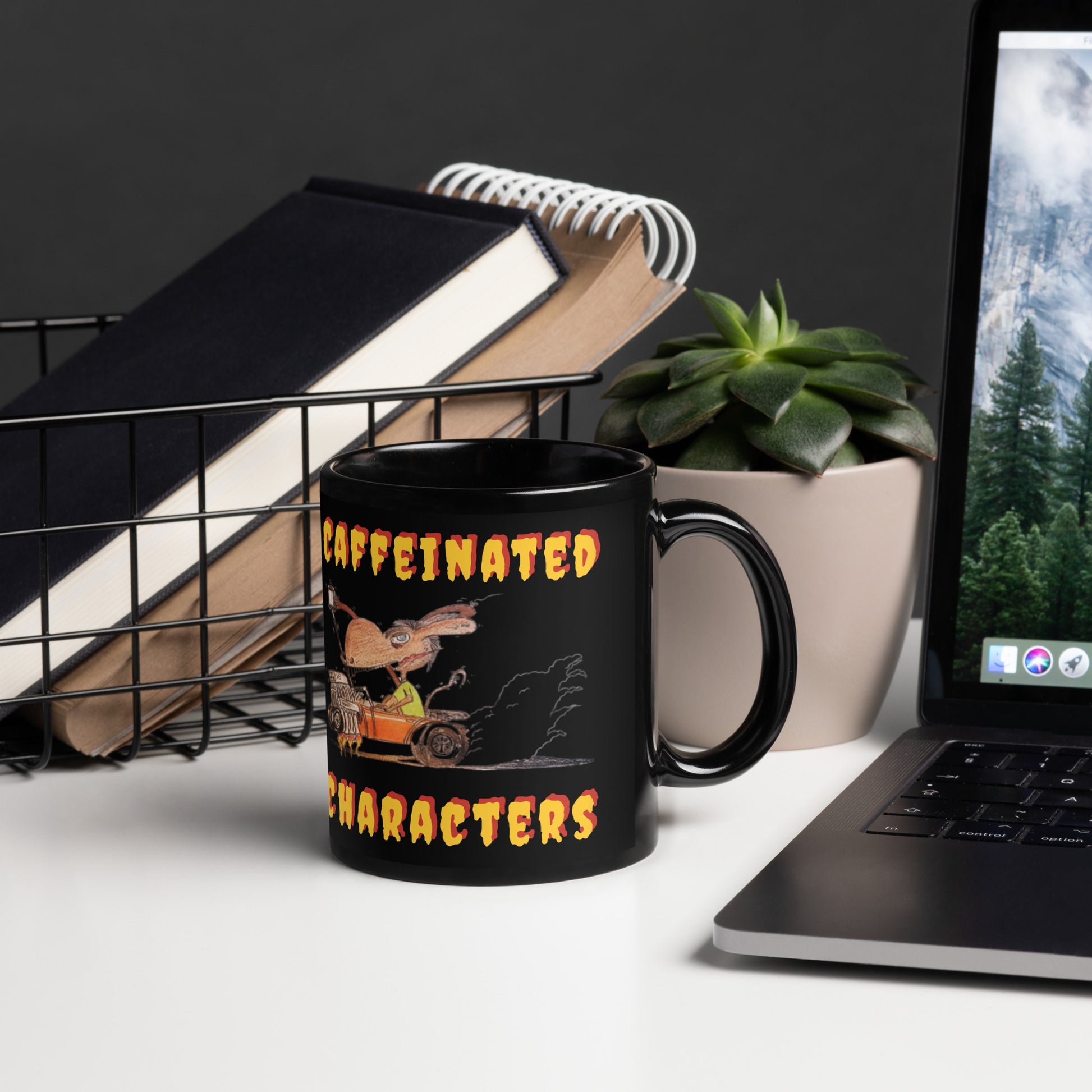 Caffeinated-Characters-black-glossy-mug-11-oz-right facing-sitting-on-a-white-desk-next-to-a-laptop, plant and some books
