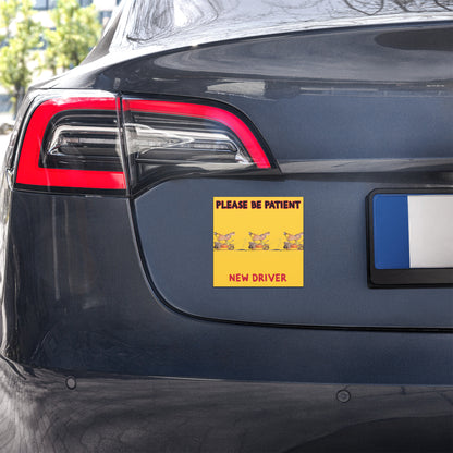Car with a humorous 'Please be patient, new driver' sticker on the back