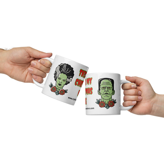 2 people holding a white-glossy-mug-20-oz-front-view-Frankenstein on one side and Frankenstein's bride on the other side