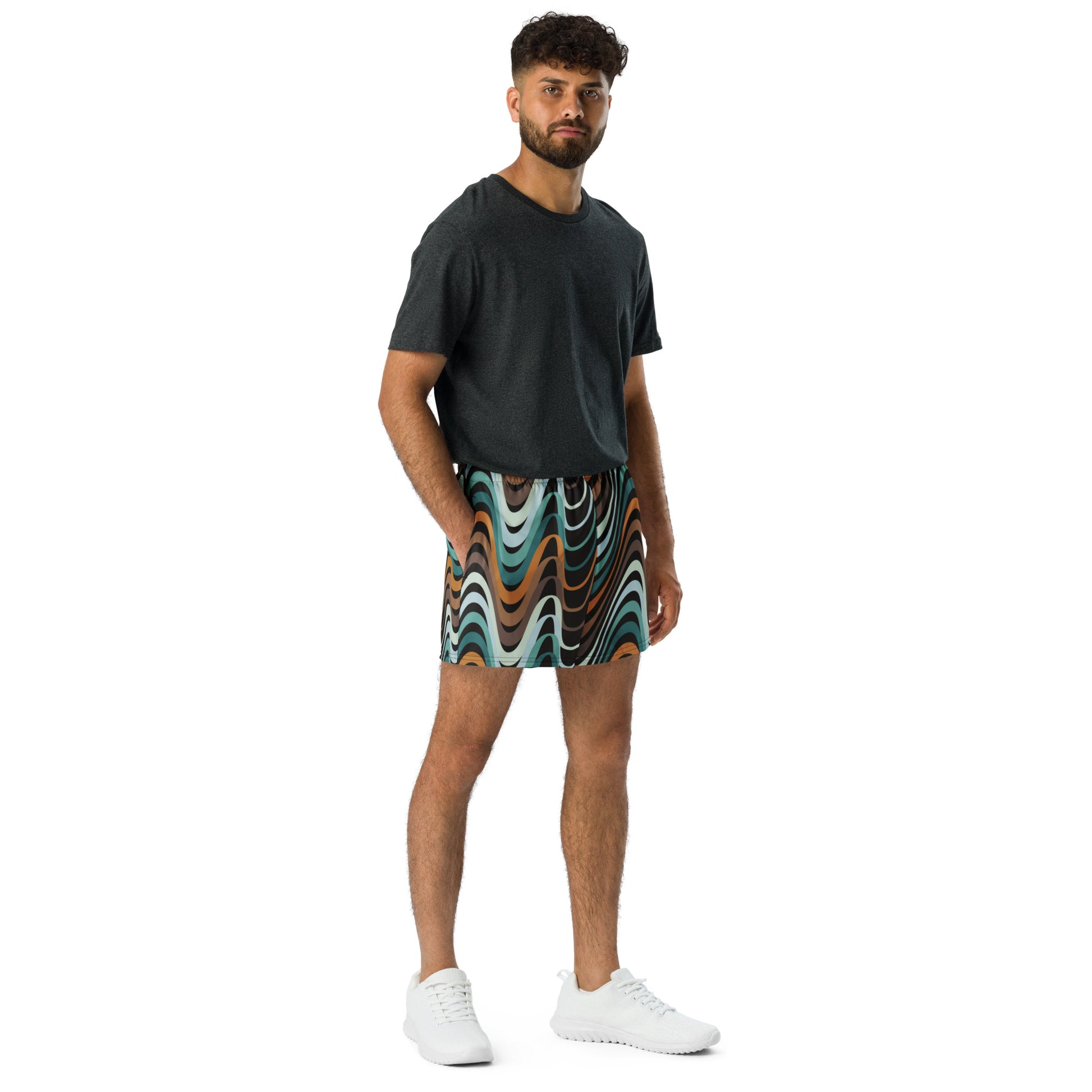 Man wearing a black t-shirt and colorful Tiki Bar style shorts on a white background