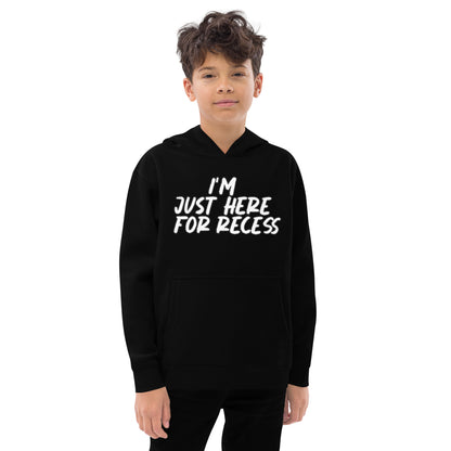 Child wearing a black hoodie with 'I'm just here for recess' text on a white background