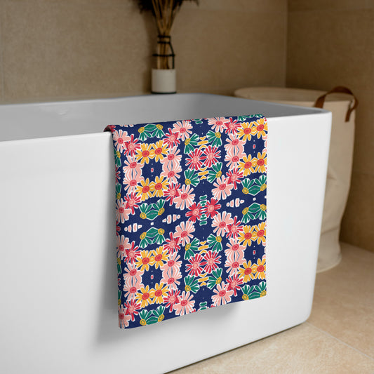 A multicolored floral beach towel draped over the side of a bathtub.