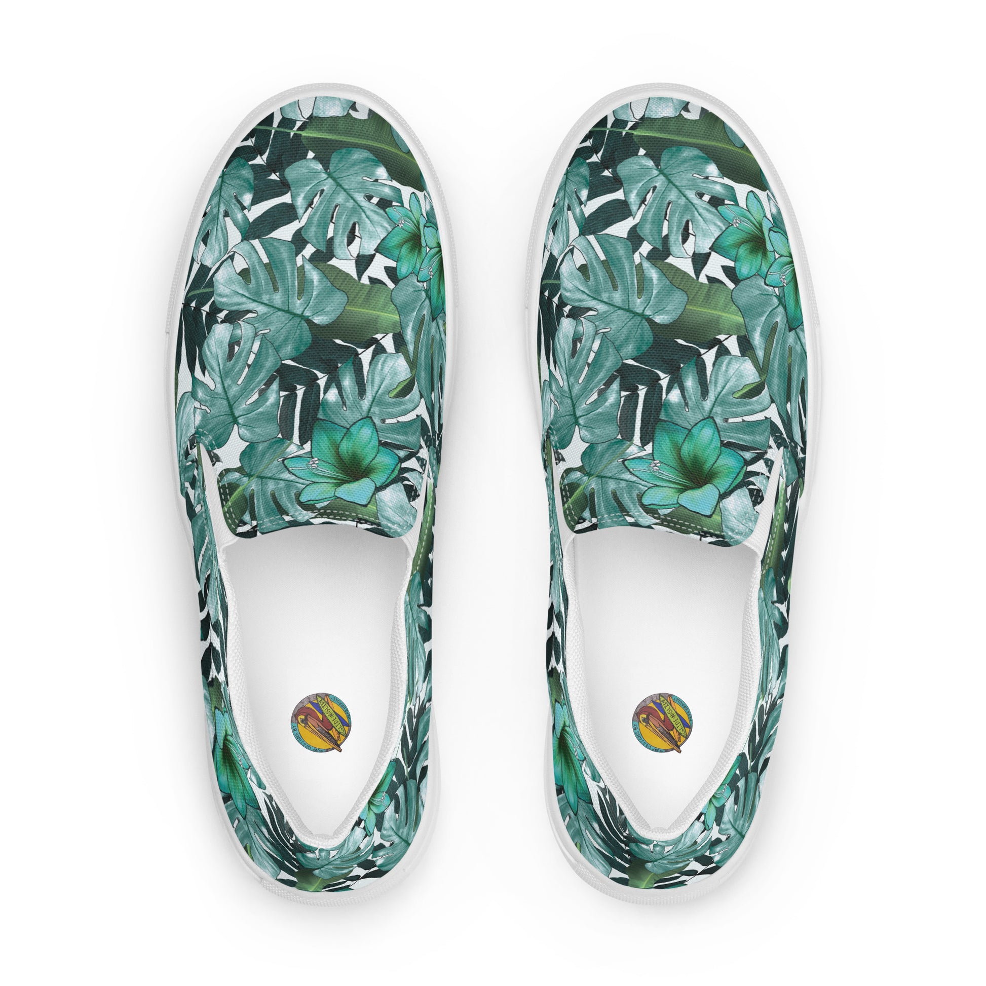 multicolor green tropical print canvas slip on shoes top view showing insole with Surf Designs By Herb Bradley Glid -n- Slide colored logo of a pelican