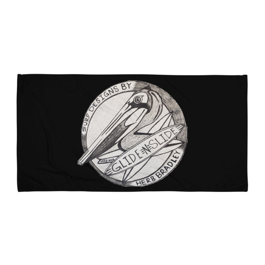 Black Glide -N- Slide Giant Beach Towel with grey and black logo laying flat on the ground