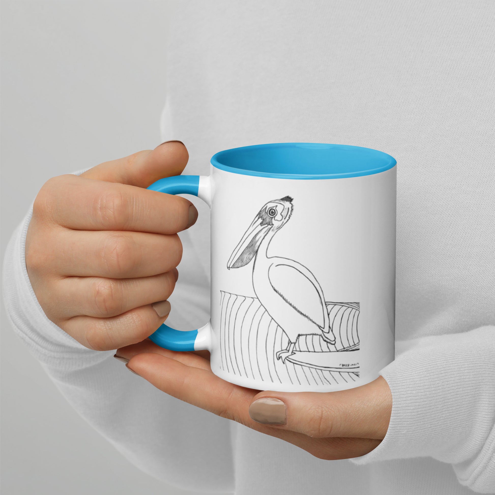 11oz Pelican Hanging Ten White mug with light blue color inside and on handle