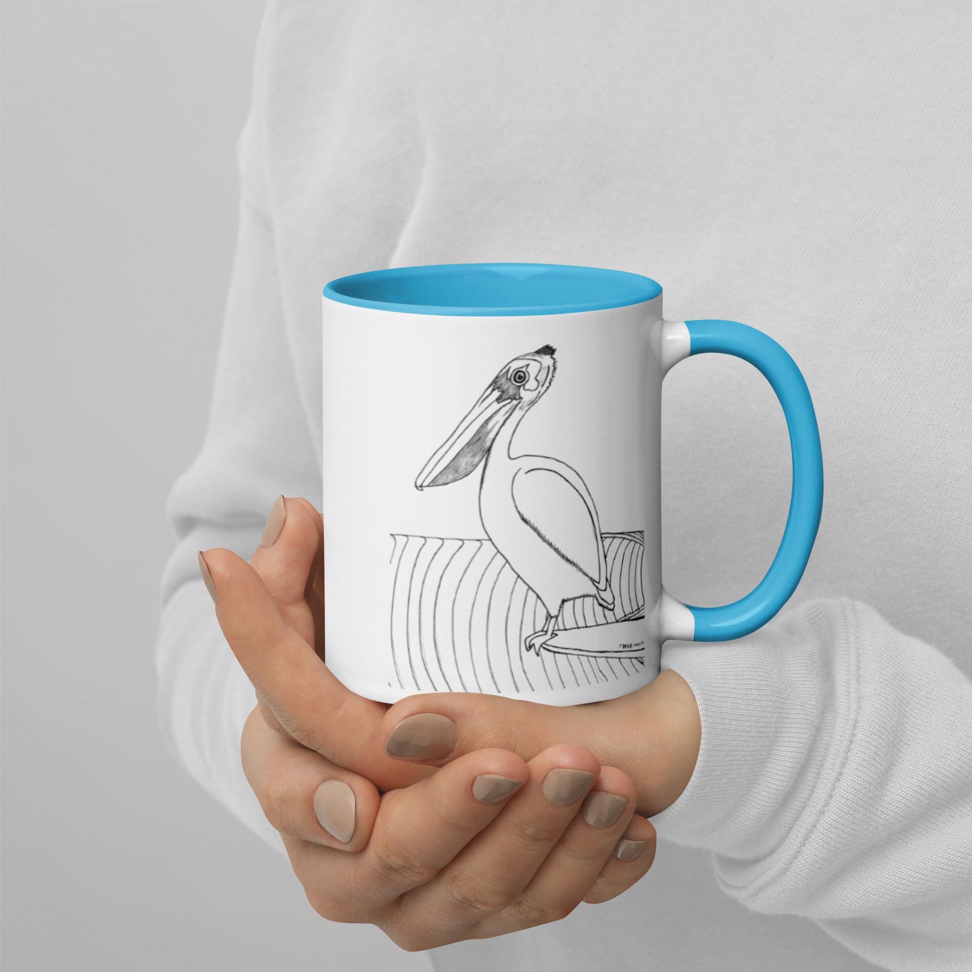 11oz Pelican Hanging Ten White mug with light blue color inside and on handle