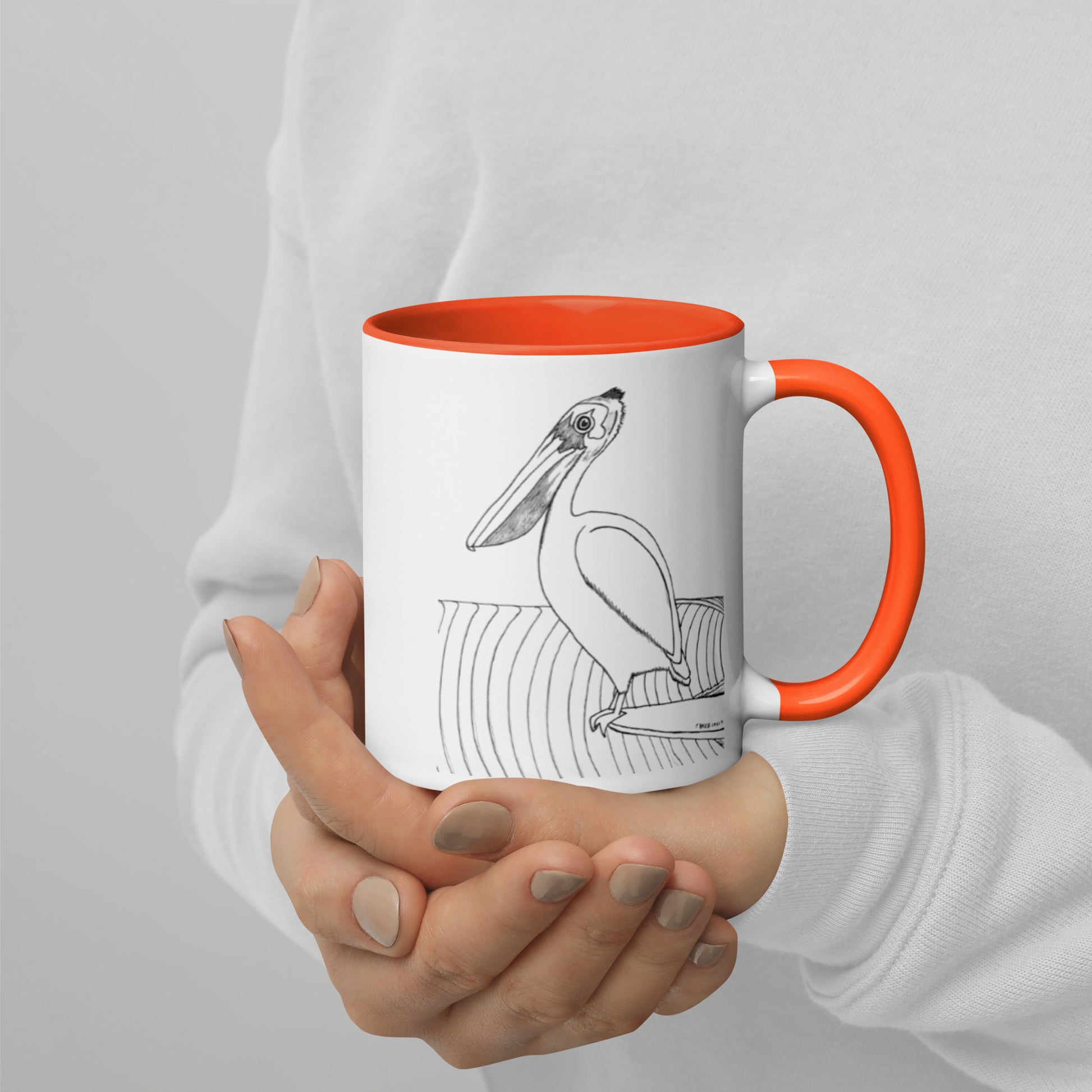 11oz Pelican Hanging Ten White mug with orange color inside and on handle