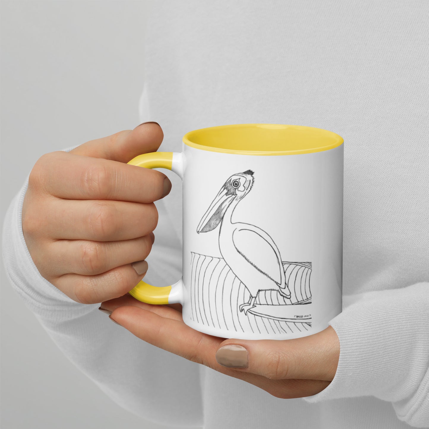 11oz Pelican Hanging Ten White mug with yellow color inside and on handle