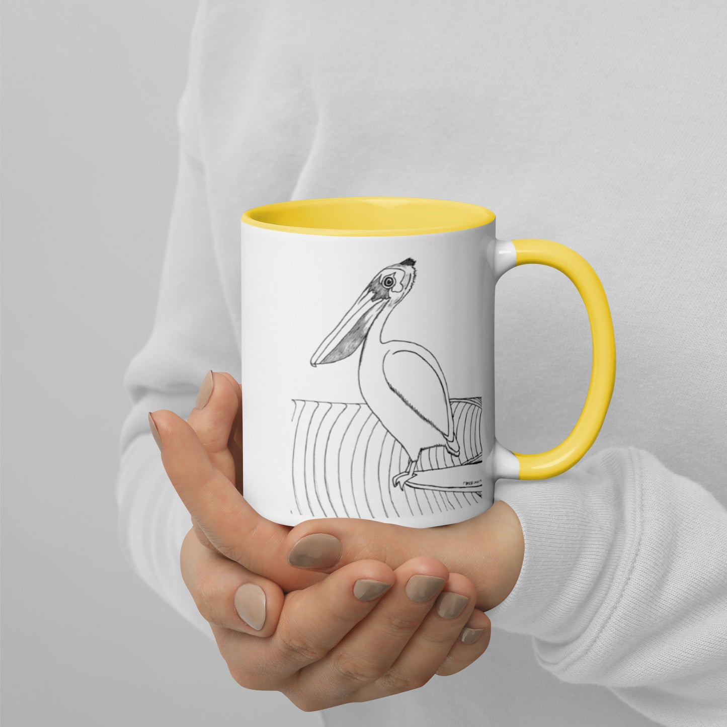 11oz Pelican Hanging Ten White mug with yellow color inside and on handle