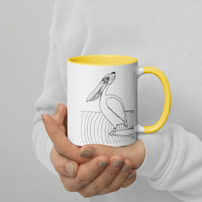 11oz Pelican Hanging Ten White mug with yellow color inside and on handle